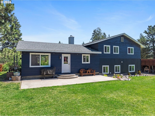 back of house with a lawn and a patio area