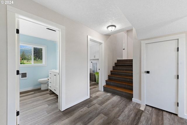 interior space with hardwood / wood-style flooring and a textured ceiling