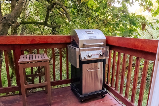 wooden deck with a grill