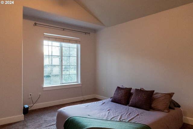 bedroom featuring vaulted ceiling and carpet