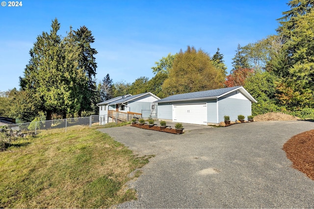 view of side of property featuring an outbuilding, a yard, and a garage