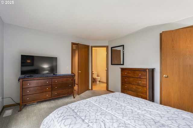 carpeted bedroom featuring ensuite bath