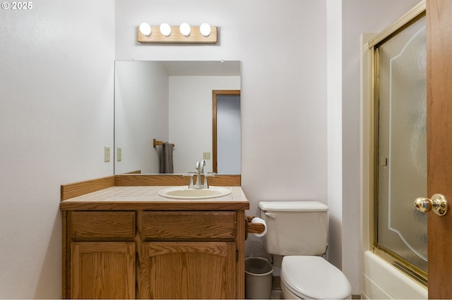 full bathroom with shower / bath combination with glass door, vanity, and toilet