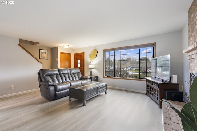 living room featuring a fireplace and light hardwood / wood-style flooring