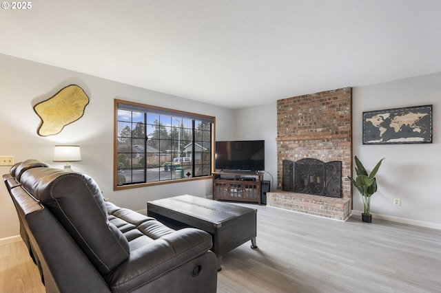 living room featuring a fireplace and light hardwood / wood-style flooring