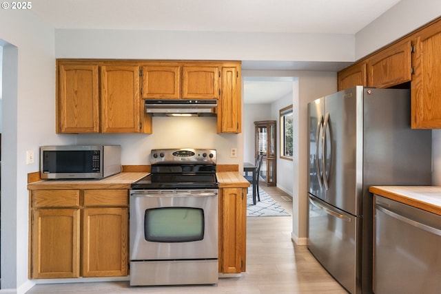 kitchen with stainless steel appliances and light wood-type flooring