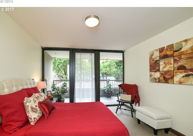 carpeted bedroom featuring a wall of windows, multiple windows, and access to outside