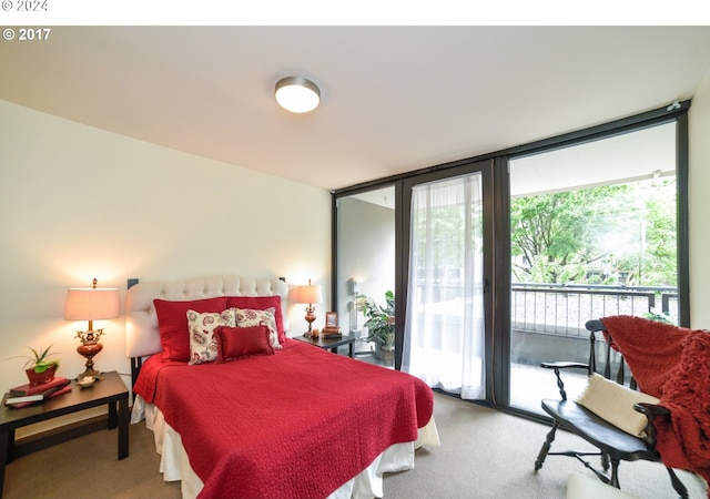 bedroom featuring carpet floors, access to outside, and a wall of windows