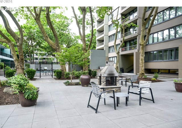 view of patio with an outdoor stone fireplace