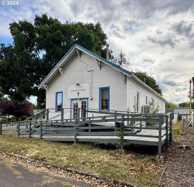 view of front of house featuring central AC unit and a wooden deck