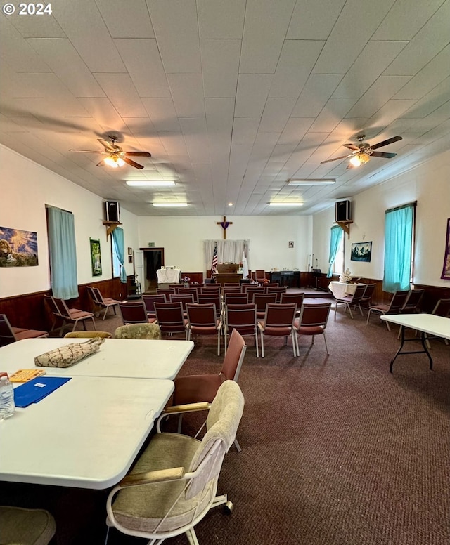 dining room with dark carpet and ceiling fan