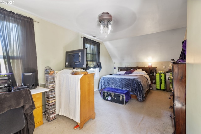 carpeted bedroom with ceiling fan and vaulted ceiling