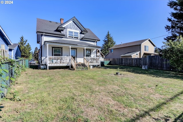 view of front of home featuring covered porch and a front yard