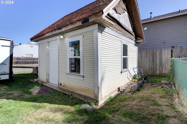 view of side of home with a lawn