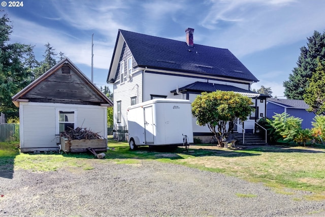 back of property featuring a lawn