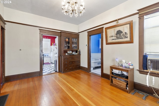 entryway featuring hardwood / wood-style flooring and a chandelier