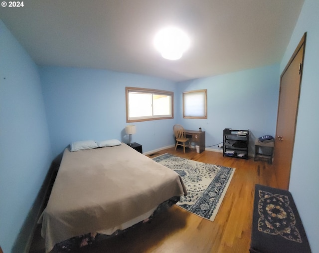 bedroom with hardwood / wood-style floors