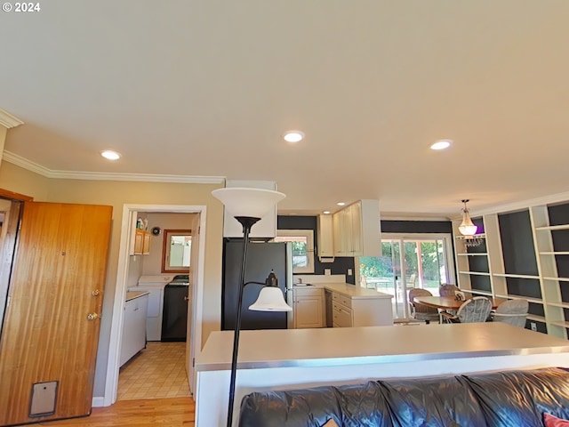 kitchen with washer / dryer, crown molding, refrigerator, hanging light fixtures, and light wood-type flooring