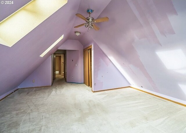 bonus room featuring lofted ceiling, carpet flooring, and ceiling fan