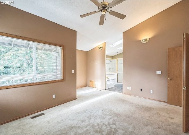 unfurnished room featuring lofted ceiling, light colored carpet, and ceiling fan