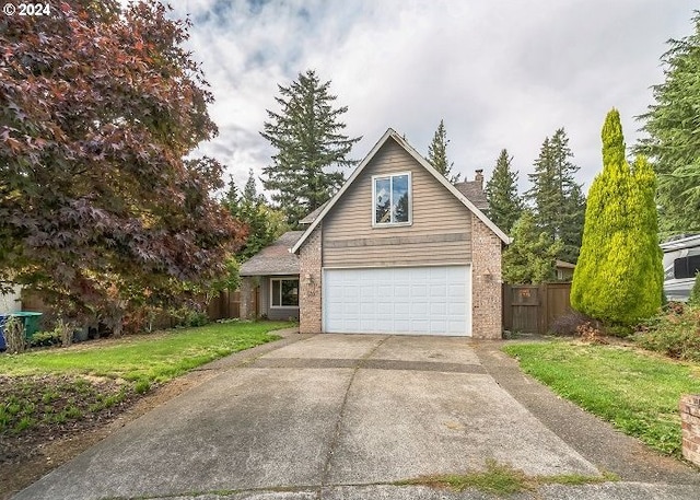 view of front of house featuring a garage and a front lawn