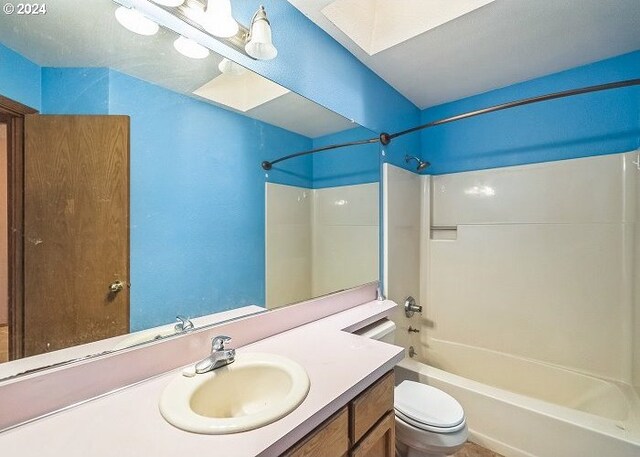 full bathroom featuring vanity, washtub / shower combination, and toilet