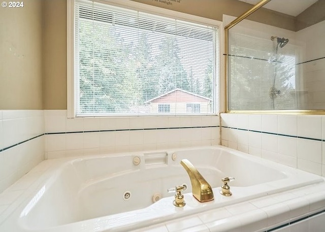 bathroom featuring shower with separate bathtub