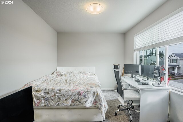 carpeted bedroom featuring a textured ceiling