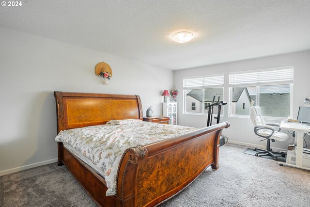 carpeted bedroom featuring a textured ceiling