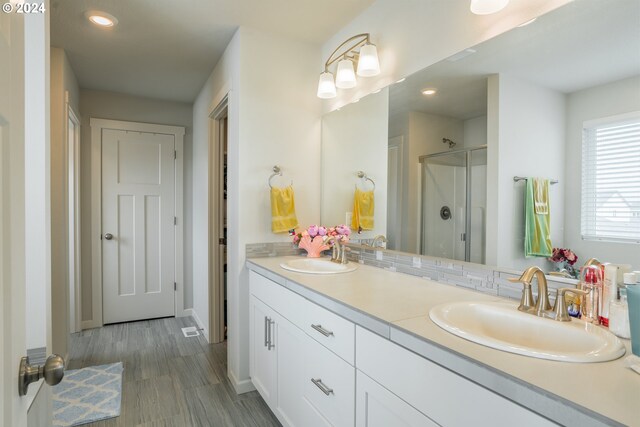 bathroom featuring vanity and a shower with shower door