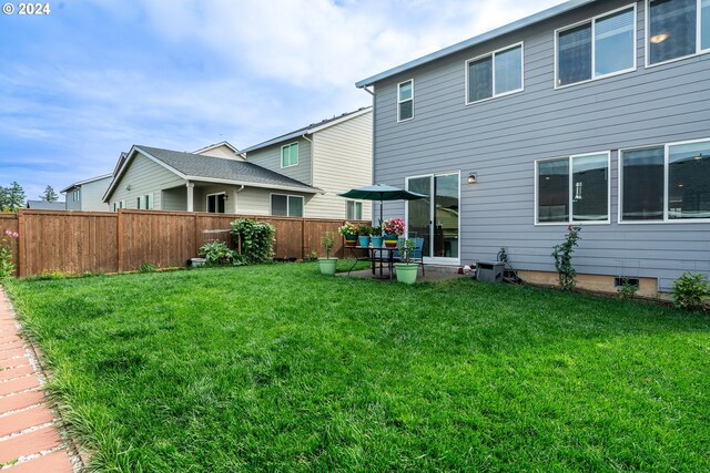 rear view of property featuring a yard