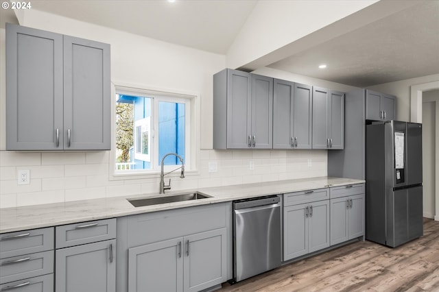 kitchen featuring gray cabinetry, tasteful backsplash, appliances with stainless steel finishes, and sink