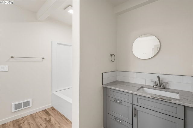 bathroom featuring vanity, beamed ceiling, separate shower and tub, and hardwood / wood-style floors