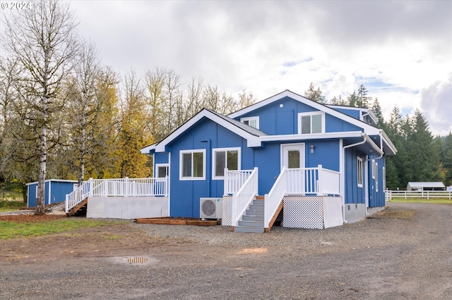 view of front of home featuring ac unit