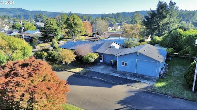 view from above of property with a heavily wooded area