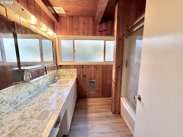 bathroom featuring wooden ceiling, wood finished floors, wood walls, healthy amount of natural light, and vanity