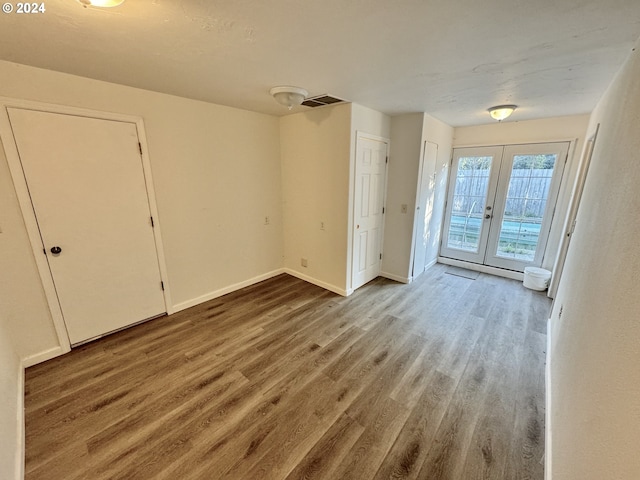 entrance foyer featuring french doors and wood-type flooring