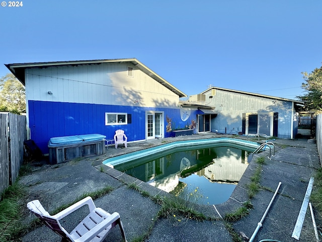 view of pool with a jacuzzi and a patio area