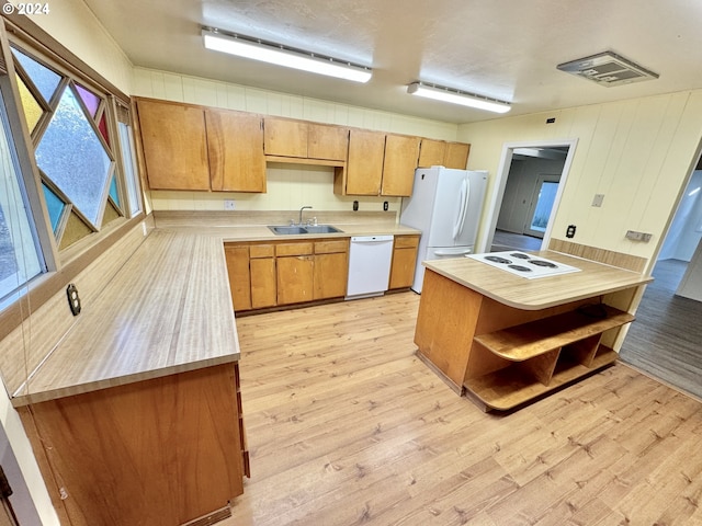 kitchen with white appliances, a sink, light countertops, light wood-type flooring, and open shelves