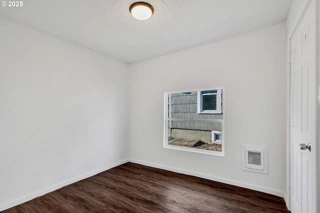 spare room featuring dark hardwood / wood-style floors