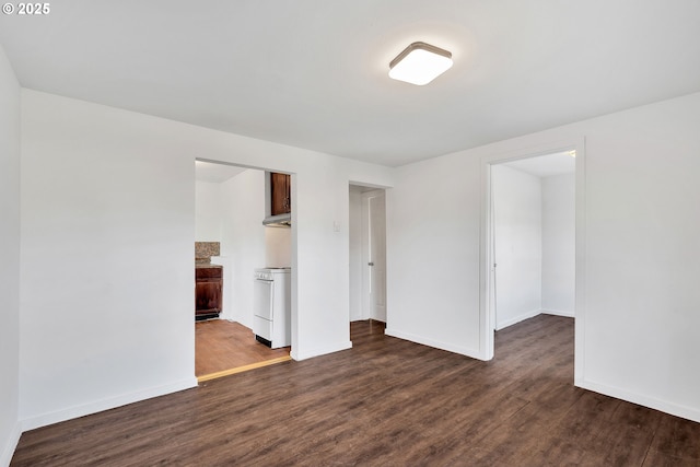 empty room featuring dark hardwood / wood-style flooring