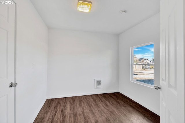 unfurnished room with dark hardwood / wood-style flooring