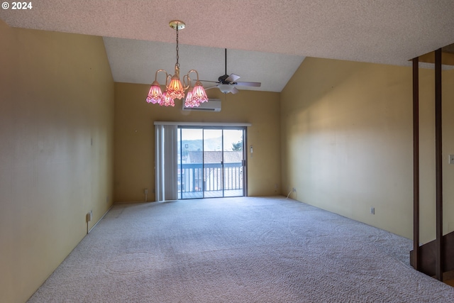 carpeted spare room with a textured ceiling, ceiling fan with notable chandelier, and vaulted ceiling