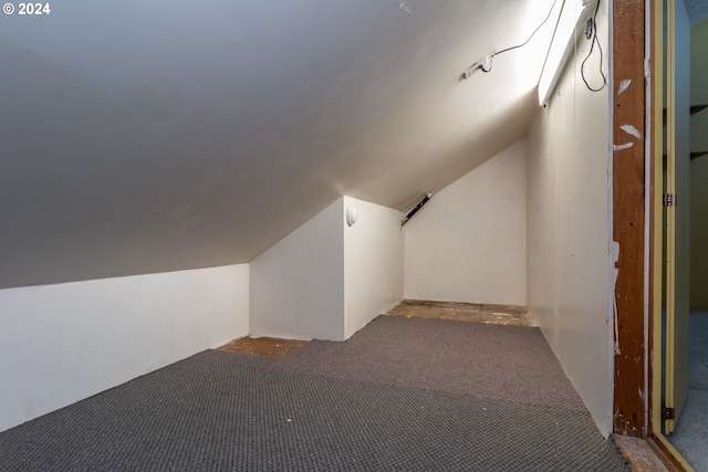 bonus room featuring vaulted ceiling and carpet flooring