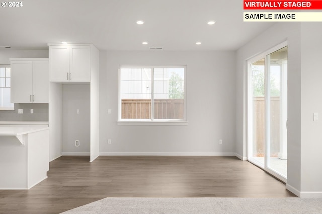 unfurnished living room featuring light wood finished floors, baseboards, visible vents, and recessed lighting