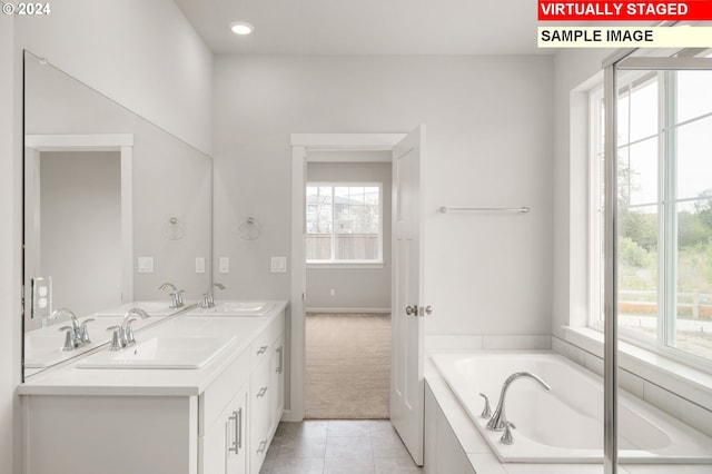 bathroom featuring double vanity, a sink, a bath, and tile patterned floors