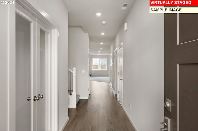 corridor with stairs, baseboards, wood finished floors, and recessed lighting