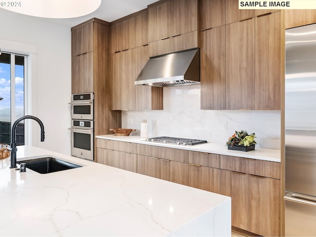 kitchen featuring stainless steel appliances, ventilation hood, a healthy amount of sunlight, and pendant lighting