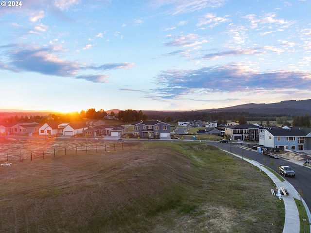 aerial view at dusk featuring a mountain view