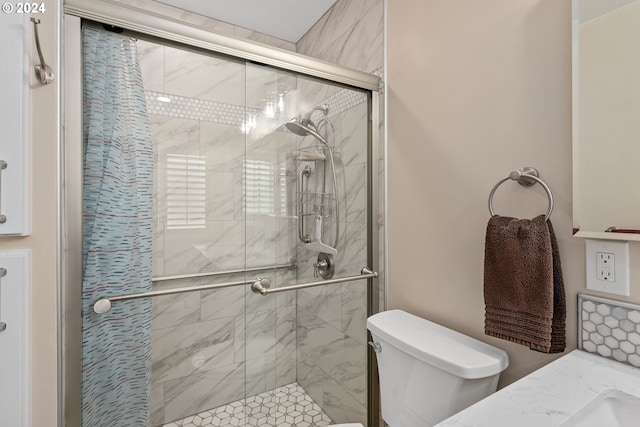 bathroom featuring toilet and a stall shower